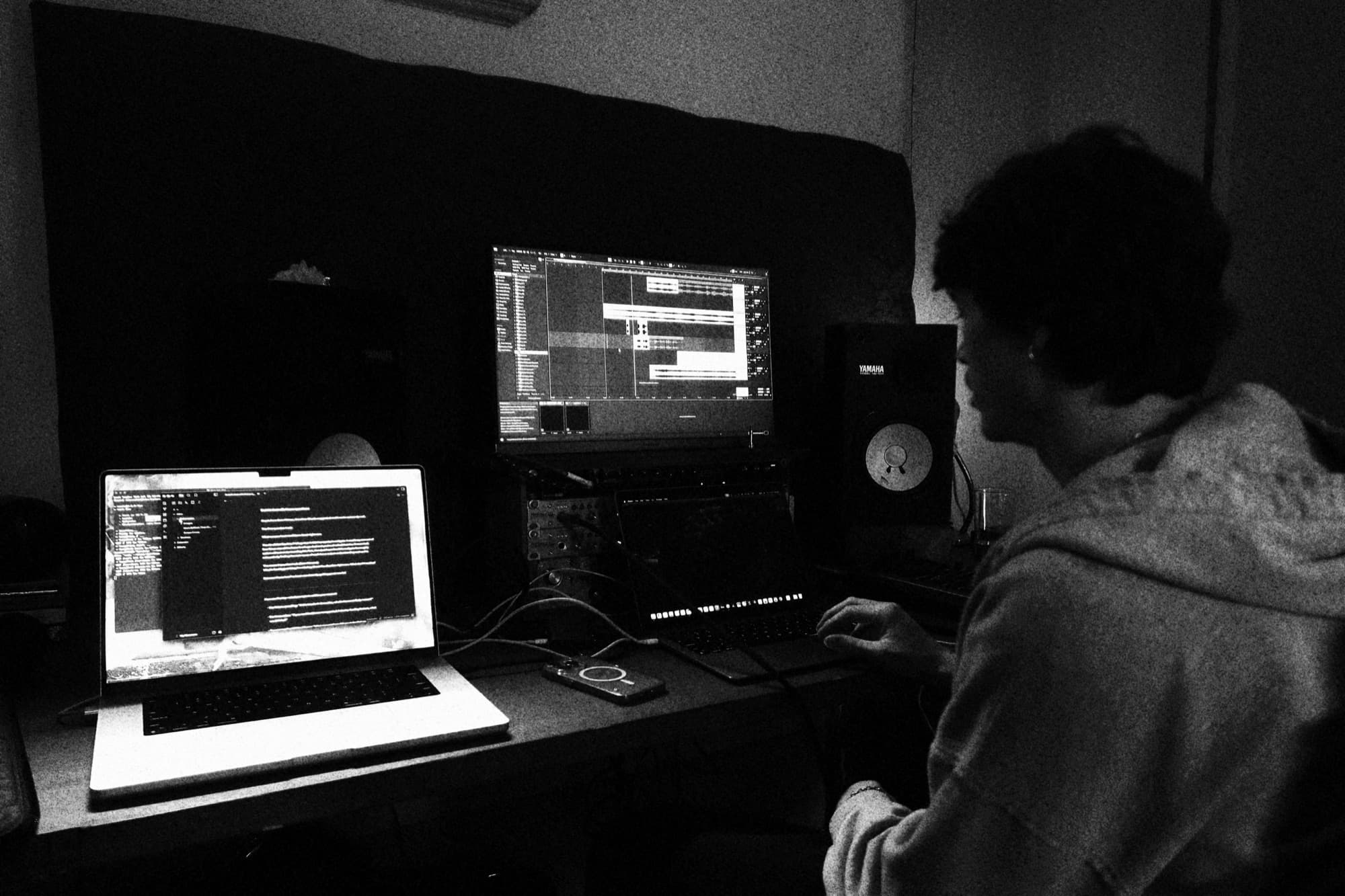 Working at the studio desk, session open on the monitor